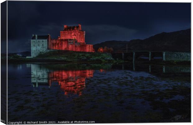 Red and white floodlighting of Eilean Donan Castle for Remembrance Sunday Canvas Print by Richard Smith
