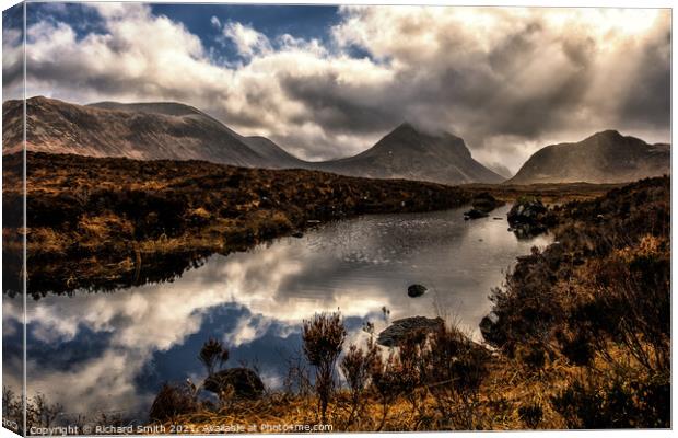 Reflections in a mountain loch, Marsco in the distance. Canvas Print by Richard Smith