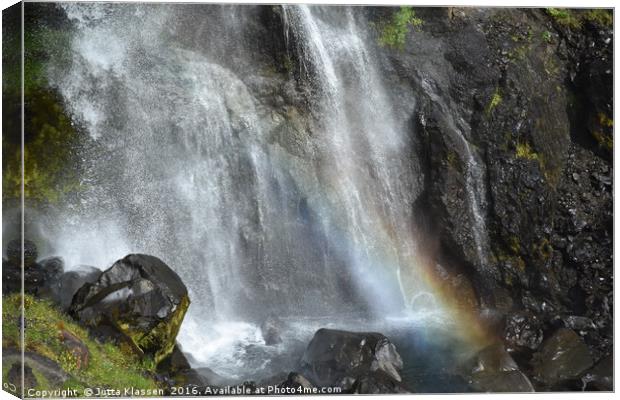 Rainbow at the bottom of a waterfall at Skaftafell Canvas Print by Jutta Klassen