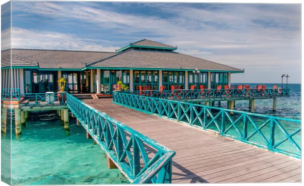 Restaurant over water in Maldives Canvas Print by Jenny Rainbow