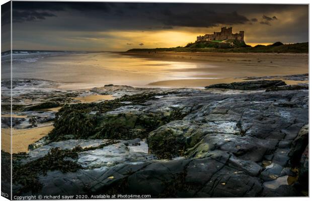 Majestic Bamburgh Castle overlooking the North Sea Canvas Print by richard sayer