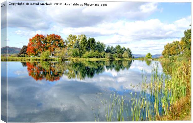 Autumn reflections on a New England lake, America. Canvas Print by David Birchall