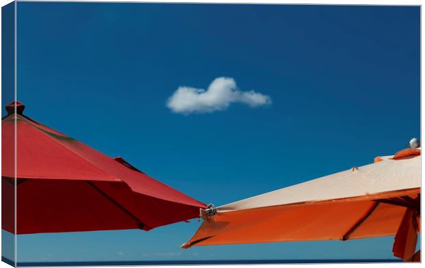 A solo cloud and parasols Canvas Print by Leighton Collins