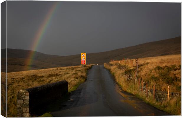 Rainbow over the mountain road Canvas Print by Leighton Collins