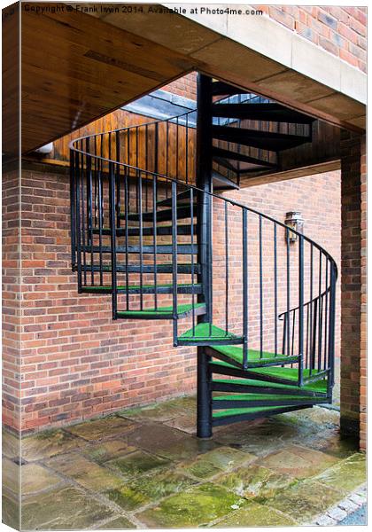 A spiral staircase used as a fire escape. Canvas Print by Frank Irwin