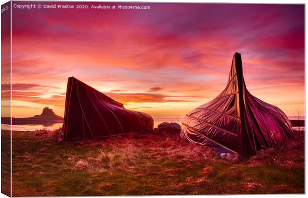 Boat huts and Lindisfarne Castle at sunrise Canvas Print by David Preston