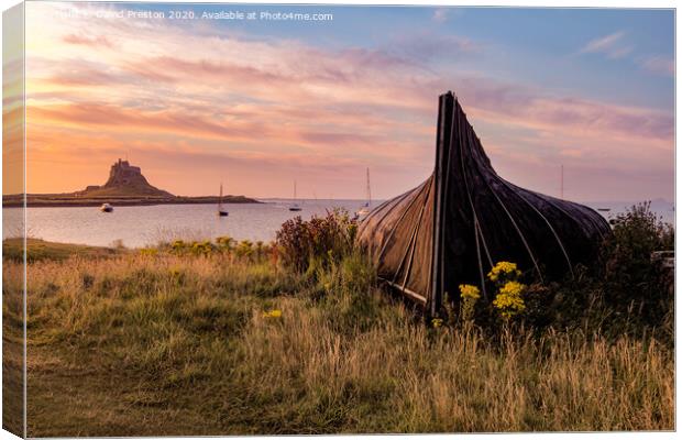 Boat hut and Lindisfarne Castle at sunrise Canvas Print by David Preston