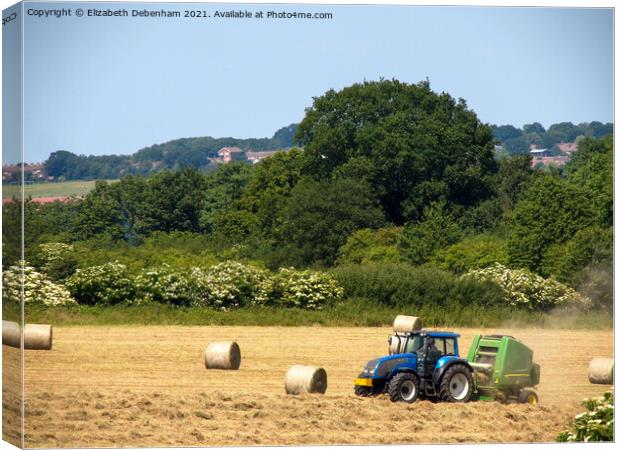 Tractor and Baler in Early Summer Canvas Print by Elizabeth Debenham