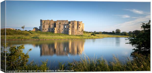 Carew Castle reflected by the evening sun  Canvas Print by Chris Warren