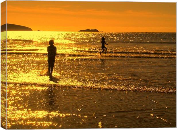 Childrens seaside splash Broadhaven sunset Canvas Print by Lindsay Read