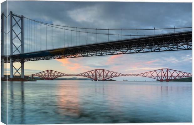 The Forth Rail Bridge framed by the Forth Road Bridge. Canvas Print by Tommy Dickson