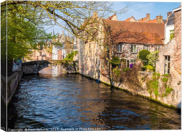 Bruges canal on a spring morning Canvas Print by Paul Nicholas