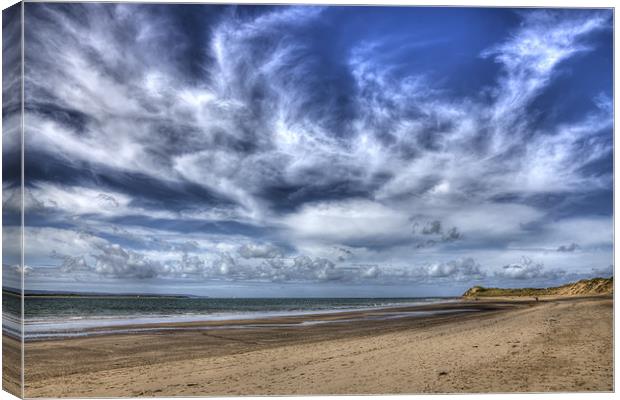 Swirling clouds and blue skies over Saunton Devon Canvas Print by Mike Gorton