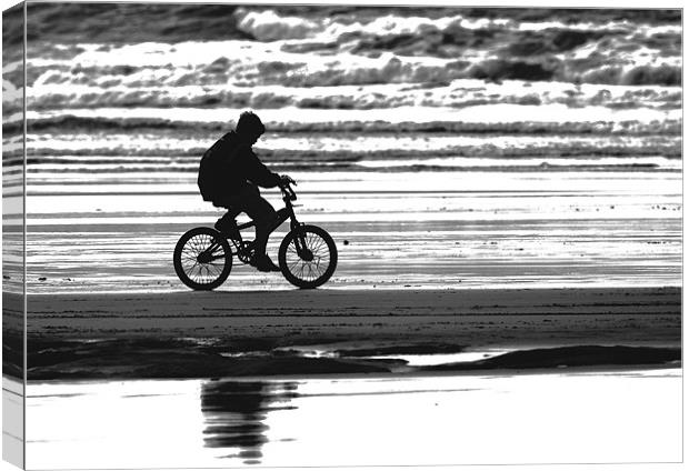 Lone Biker on Westward Ho! beach Canvas Print by Mike Gorton