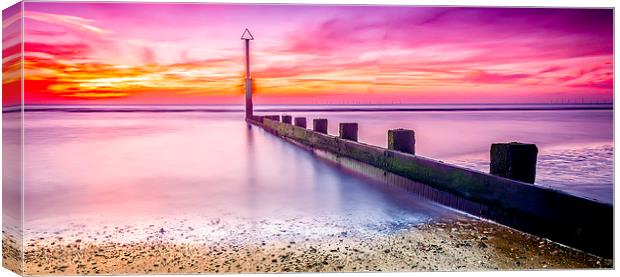 A Glowing Sunset at Rhyl Beach Canvas Print by Darren Wilkes