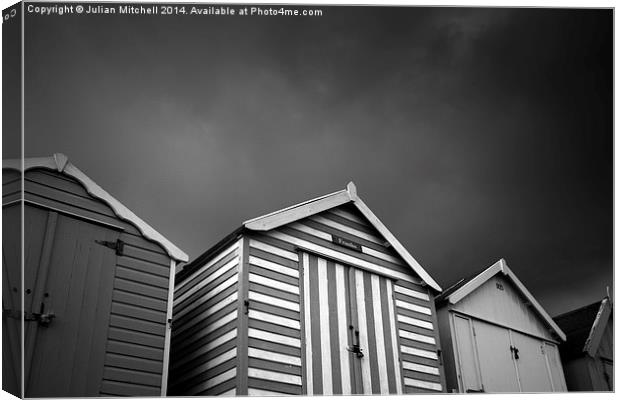 Stormy Beach Huts Canvas Print by Julian Mitchell