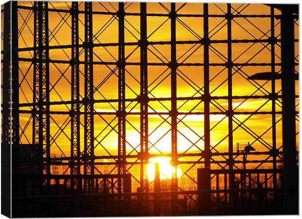 Sunset through gas holder Canvas Print by Andy Huntley