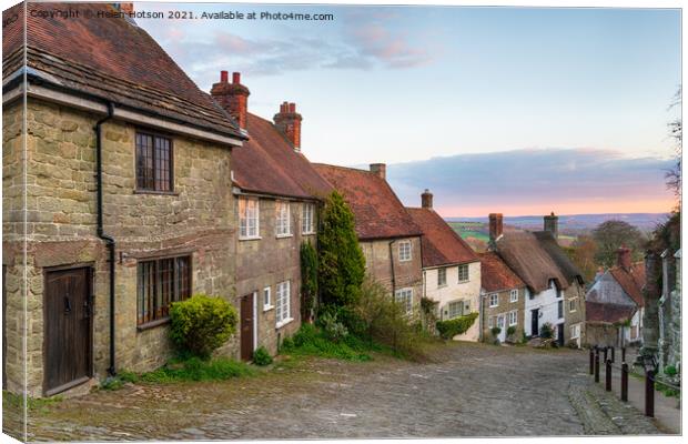 Sunset over cottages on a cobbled street Canvas Print by Helen Hotson