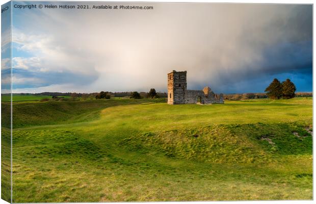 Dramatic skies over the old church at Knowlton  Canvas Print by Helen Hotson
