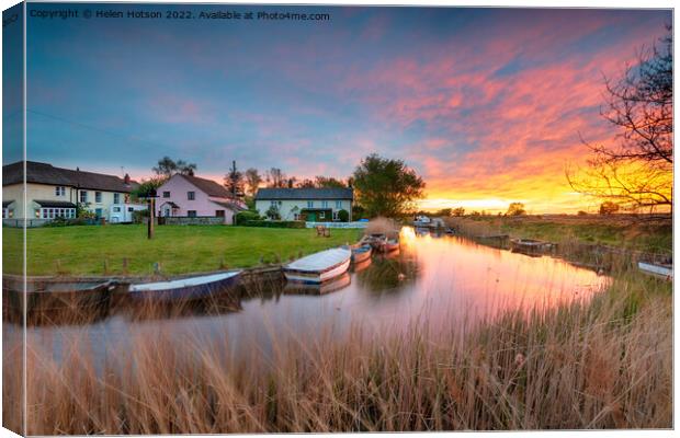 Stunning sunset over the village green and boats on the river at Canvas Print by Helen Hotson