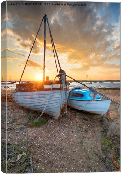 Stunning sunset over old fishing boats on the shore at West Mers Canvas Print by Helen Hotson