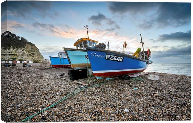 Fishing boats on the beach at Beer in Devon Canvas Print by Helen Hotson