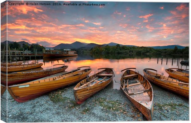 Stunning sunset over wooden rowing boats on Derwen Canvas Print by Helen Hotson