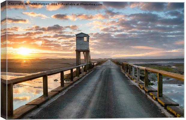 Sunrise over Holy Island Canvas Print by Helen Hotson