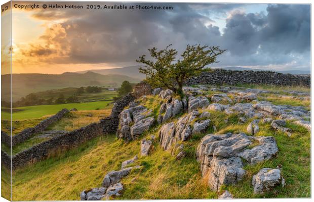 Stormy sunset over a small limestone pavement Canvas Print by Helen Hotson