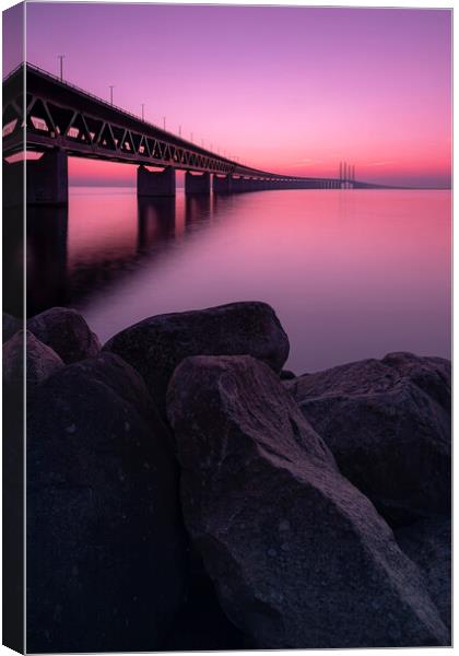 Oresunds Bridge and Rocky Shore at Sunset Canvas Print by Antony McAulay