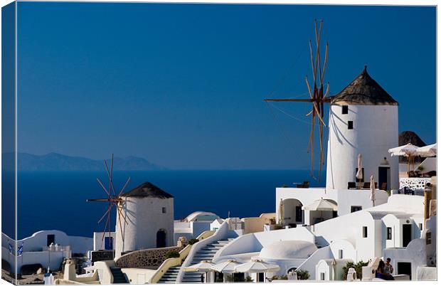 Windmills Of Oia Canvas Print by Mark Robson