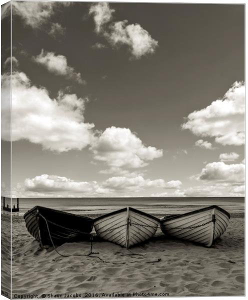Fishing boats on a beach Canvas Print by Shaun Jacobs