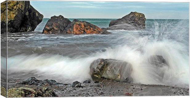 Waves against the rocks Canvas Print by Derek Dobbie