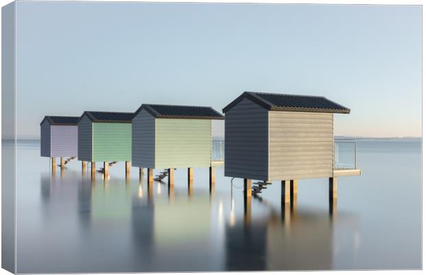 Pastel Beach Huts at high tide Canvas Print by Kelvin Trundle