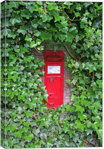 A red Victorian post box in an ivy covered wall Canvas Print by John Keates