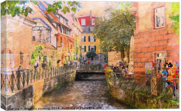 A stream in a town  Canvas Print by sylvia scotting