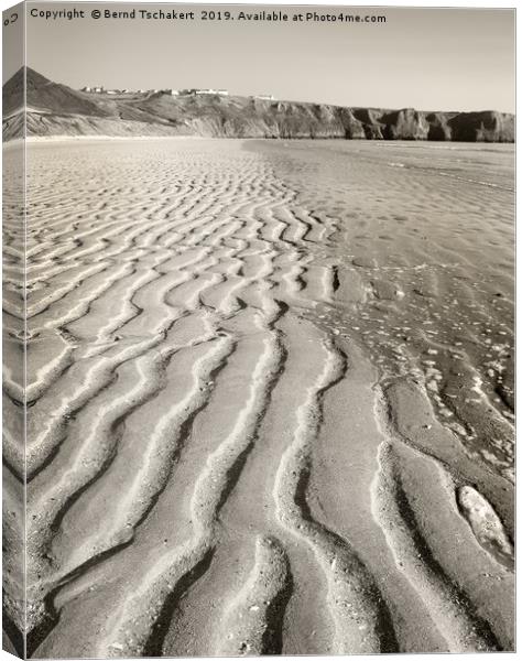 Sand patterns beach, Rhossili village, Gower, UK Canvas Print by Bernd Tschakert