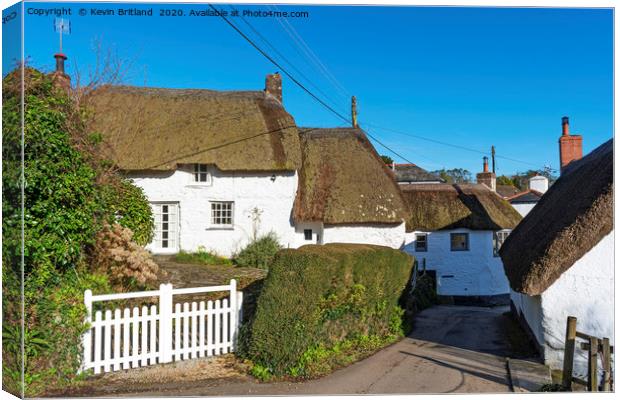 Thatched roof cottages Canvas Print by Kevin Britland