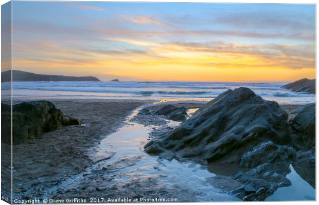 Fistral Beach Sunset by the rocks Canvas Print by Diane Griffiths