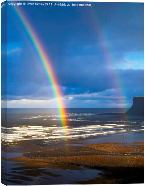 Saltburn Beach  in winter sunshine blue sky  with a double rainbow and a  distant view of looking towards Warsett hill  Canvas Print by Peter Jordan