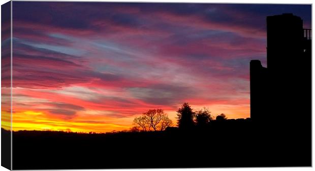 A sunset at Kenilworth Castle Canvas Print by John Evans