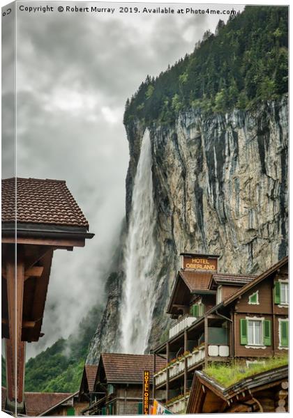 Lauterbrunnen town with waterfall backdrop Canvas Print by Robert Murray