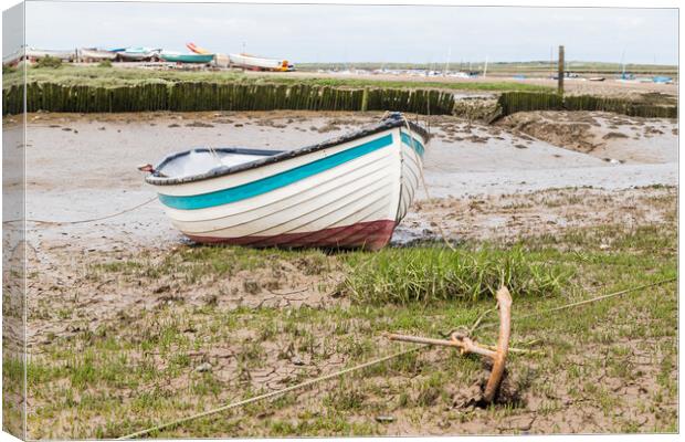 Boat anchored to the shore at Brancaster Staithe Canvas Print by Jason Wells