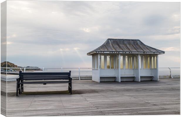 Bench and shelter on Cromer Pier Canvas Print by Jason Wells