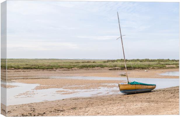 Sailing boat beached at low tide at Blakeney Canvas Print by Jason Wells
