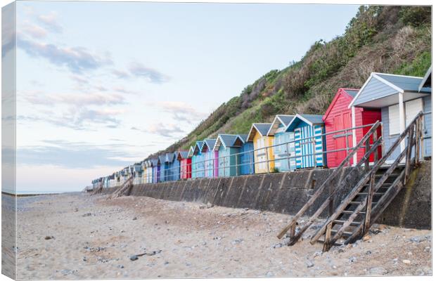Beach huts line the promenade at Cromer Canvas Print by Jason Wells