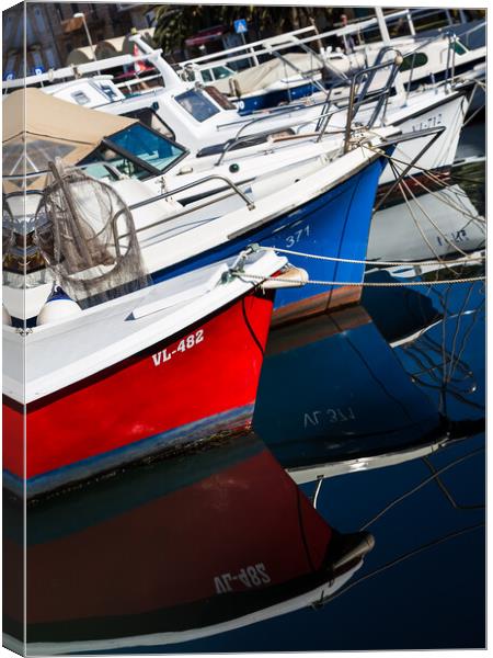 Boats reflecting in the water Canvas Print by Jason Wells