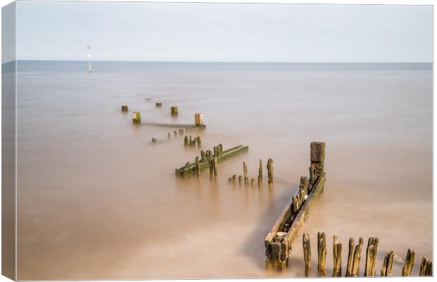 Zig zag groyne at Hunstanton beach juts out into The Wash Canvas Print by Jason Wells