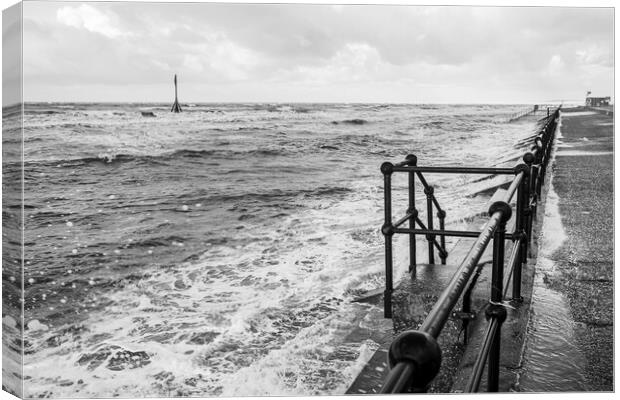 Waves breaking onto the promenade at Crosby Canvas Print by Jason Wells