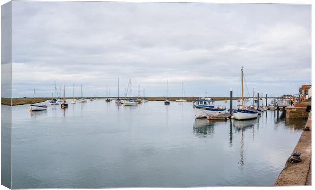 Boats on the calm water at Wells next the Sea Canvas Print by Jason Wells
